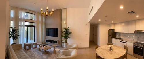a kitchen and living room with a table and a couch at Madinat Jumeirah Living - Lamtara 2 in Dubai