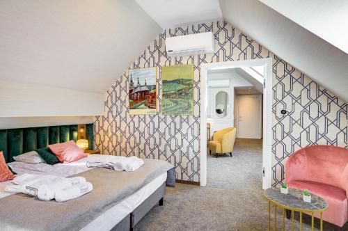 two beds in a room with a wall at Hotel Willa Tatrzańska in Krynica Zdrój