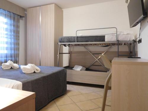 um pequeno quarto com 2 beliches em Gabbiano Apartments em Rimini