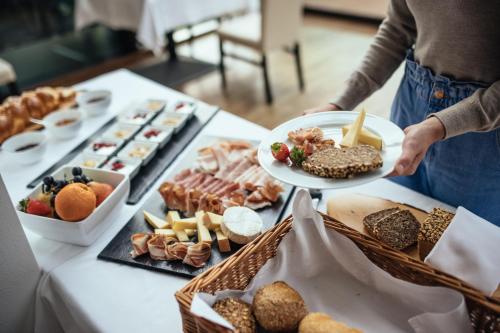 a table topped with lots of different types of food at Hotel Rablanderhof in Rablà