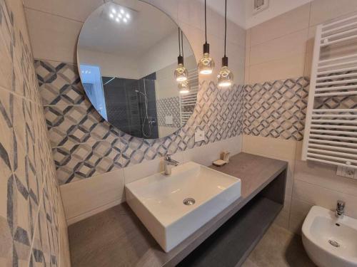 a bathroom with a sink and a mirror at Pitla Cuna - Eco Relais in Terlano