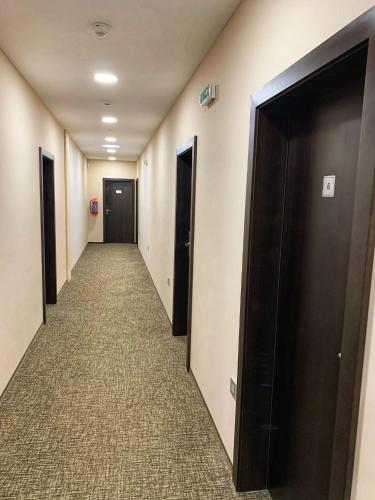 a corridor of a hallway with two doors and carpet at Penzion U Broucka in Milevsko