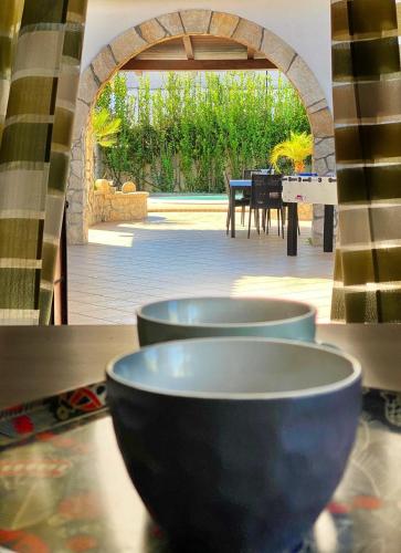 a row of bowls sitting on a table with a patio at Villa Francesca in Fontane Bianche