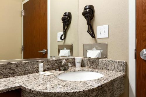a bathroom with a sink and a telephone at Microtel Inn & Suites by Wyndham in Shelbyville