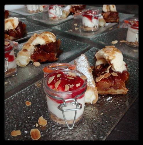 a bunch of desserts on a counter with jam and cream at Casa Da Urcela in Ponteareas