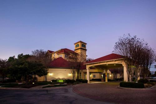 a large brick building with a clock tower at La Quinta by Wyndham Austin Southwest in Austin