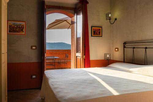a bedroom with a bed and a window with a table at BioAgriturismo Antica Sena in Milici