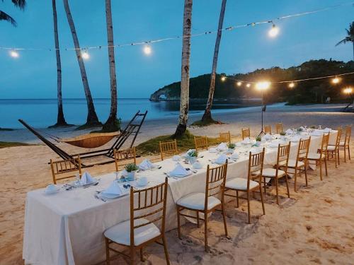 a table set up on the beach at night at Belmont Hotel Boracay near Newcoast Beach in Boracay