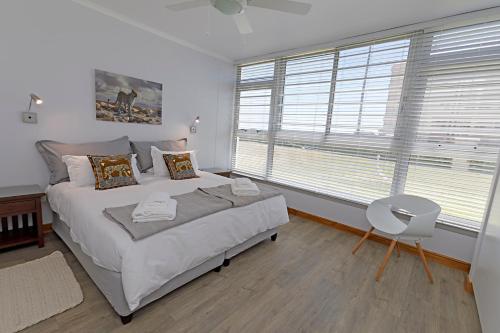 a bedroom with a large bed and a window at Ocean-Song in Strand