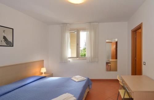 Ένα ή περισσότερα κρεβάτια σε δωμάτιο στο Residence San Rossore