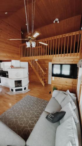 a bedroom with a bed and a wooden ceiling at Jukuvilla in Kalajoki