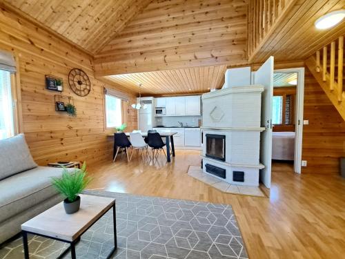 a living room with a couch and a fireplace at Jukuvilla in Kalajoki