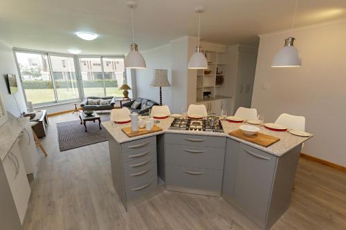 a kitchen with an island in the middle of a room at Ocean-Song in Strand