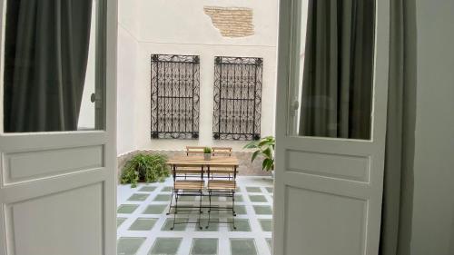 a dining room with a table and chairs through the door at Planeta Cadiz Hostel in Cádiz