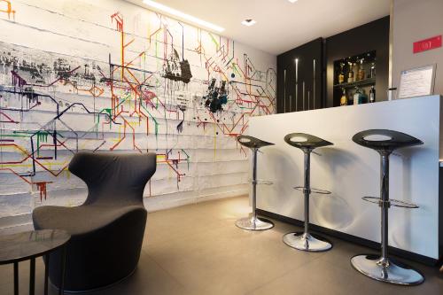 a bar with three stools and a wall covered in graffiti at Arc de Triomphe Etoile in Paris