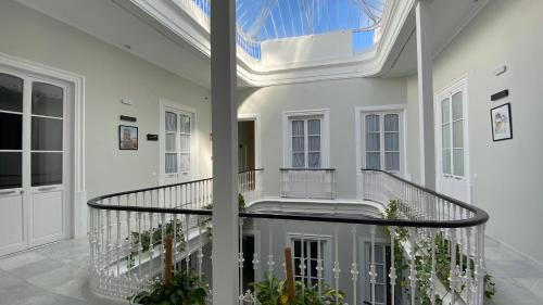 a large white house with a skylight at Planeta Cadiz Hostel in Cádiz