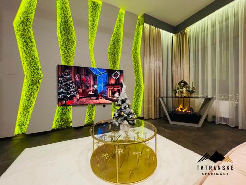 un salon avec une table en verre et une télévision dans l'établissement Luxusný Apartmán Hrebienok Resort - Tatranské Apartmány, à Starý Smokovec