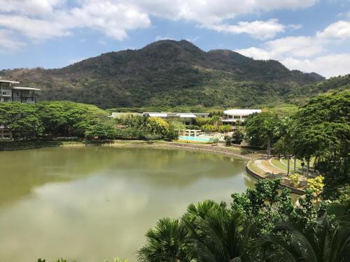 a large pond in front of a mountain at Creys Condo 2 at Pico de Loro Cove in Nasugbu