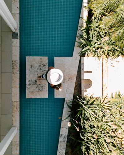 an overhead view of a swimming pool with a person at Radisson Blu Azuri Resort & Spa in Roches Noires
