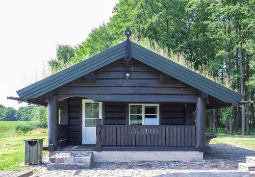 a small log cabin with a pitched roof at Dvarčėnų dvaras in Dvarčėnai