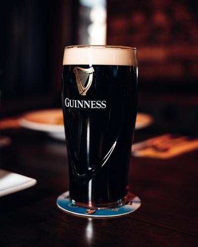 a glass of beer sitting on a table at Beechlawn Hotel in Belfast