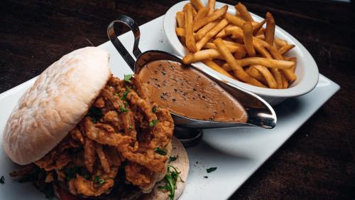 a plate of food with a sandwich and french fries at Beechlawn Hotel in Belfast