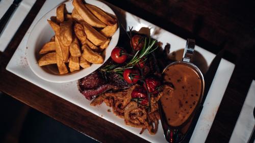 a plate of food with french fries and meat at Beechlawn Hotel in Belfast