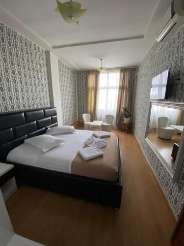 a bedroom with a large bed in a room at Hotel Arberia in Tirana