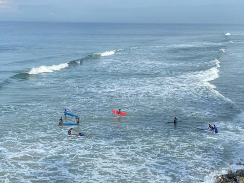 a group of people swimming in the ocean at Tattwamasi Ayuryoga with Breakfast and Yoga in Varkala