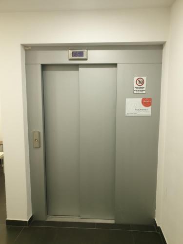 a elevator door in a building with a sign on it at bookVienna "JiM" Apartments in Vienna