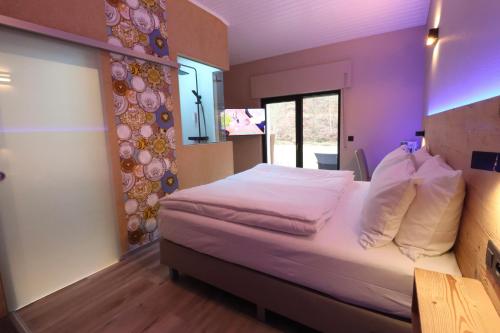 a bedroom with a bed in a room at Hotel Val de l'Our in Burg-Reuland