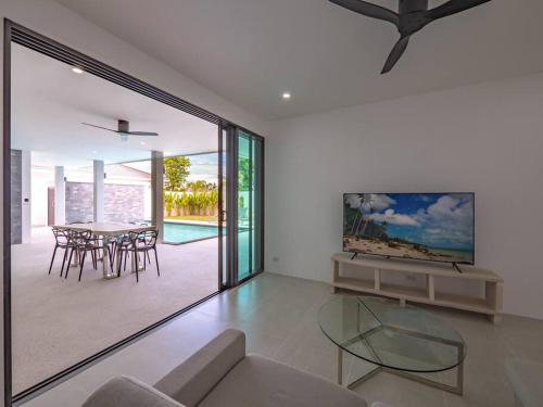 a living room with a glass table and chairs at Villa Selena in Lamai