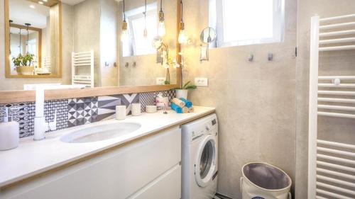 a bathroom with a sink and a washing machine at Cozy apartment in the heart of Mali Lošinj - 45 m² with view in Mali Lošinj