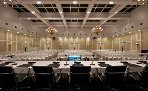 a large banquet hall with white tables and chairs at Royale Chulan Damansara in Petaling Jaya