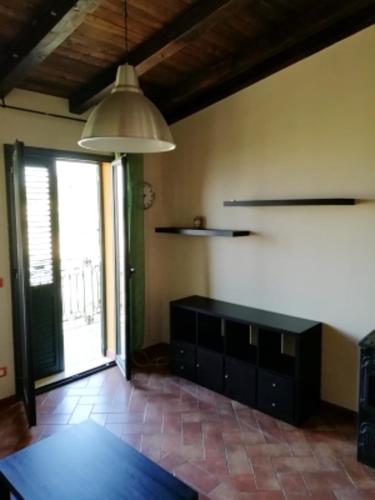 a living room with a table and a large window at One bedroom appartement with city view enclosed garden and wifi at Caltanissetta in Caltanissetta