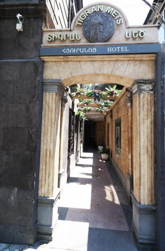 an entrance to an old building with a sign for a hotel at Hotel Tigran Mets Yerevan in Yerevan
