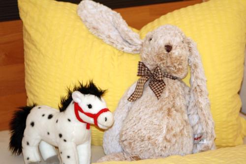 two stuffed animals sitting on a couch with a horse at Cafe Wastelbauerhof - Urlaub auf dem Bauernhof in Bernau am Chiemsee