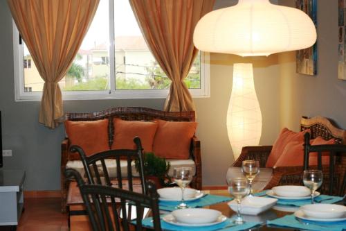 a dining room with a table and a couch at Bavaro Green in Punta Cana