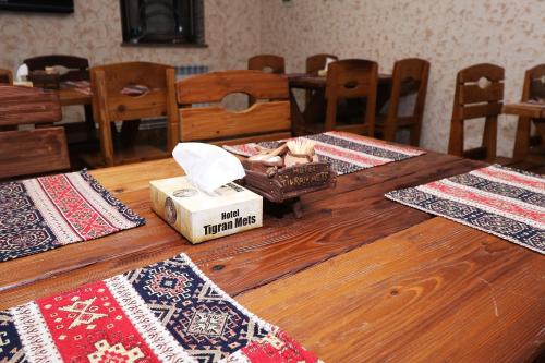 a wooden table with mats and a box on it at Hotel Tigran Mets Yerevan in Yerevan