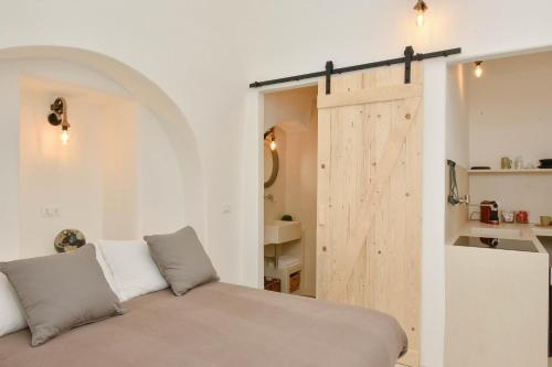 a room with a bed and a sliding barn door at CASA FLAMI' 3 in Ostuni