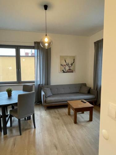 a living room with a couch and a table at Apartamenty Komorniki in Komorniki