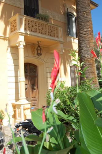 a house with a balcony and a red flower at Arena Alfieri B&B in Livorno