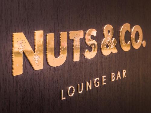 a sign for a loungesuce bar with gold writing at AlpenGold Hotel Davos in Davos
