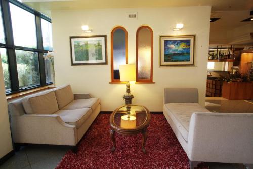 a living room with two couches and a table at Hotel Cristallo di La Rosetta Srl in Assisi
