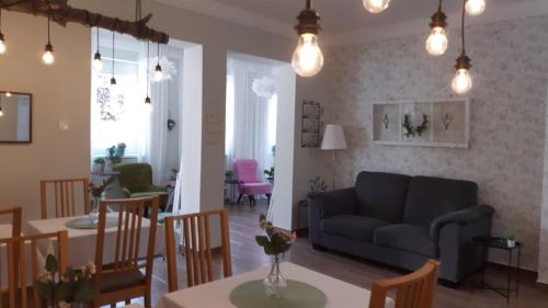 a living room with a couch and a table at City Inn Szigetvar in Szigetvár