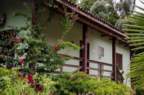 a building with pink flowers on the side of it at Residenciais Belo Centro Gramado in Gramado