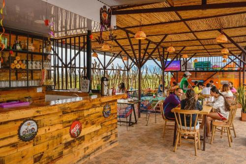 a group of people sitting at tables in a restaurant at Tubo Hotel La Tatacoa in Villavieja