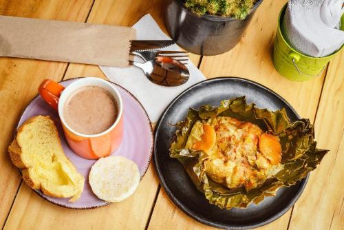 a table with a plate of food and a cup of coffee at Tubo Hotel La Tatacoa in Villavieja