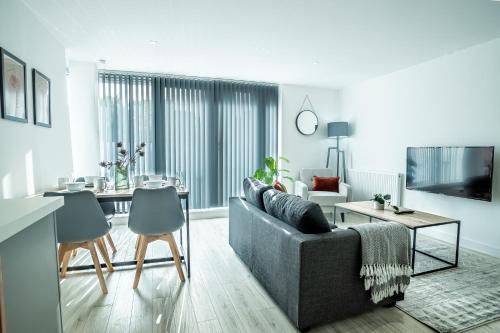 a living room with a couch and a table at Modern Luxe 1 & 2 Bed Apts near Granby Plaza by Sojo Stay in Leicester