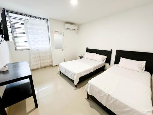 Postel nebo postele na pokoji v ubytování Hotel Acosta Castro